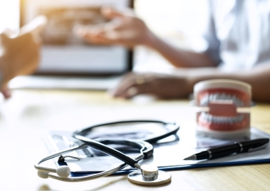 Stethoscope on table with paperwork